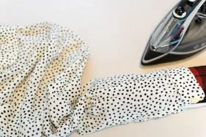 Pressing clothing with iron